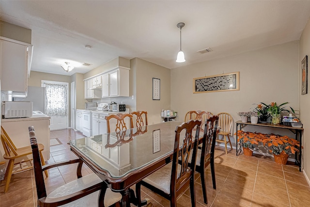 dining area featuring light tile patterned floors