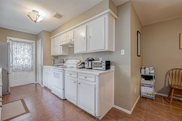 kitchen with light tile patterned floors, white cabinets, stainless steel fridge, and white electric range oven