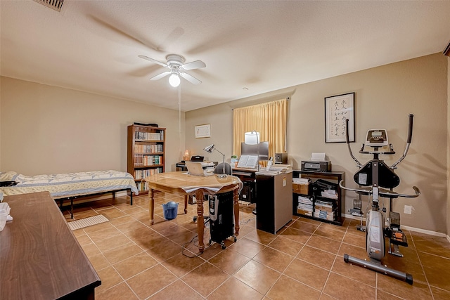 tiled office featuring ceiling fan and a textured ceiling