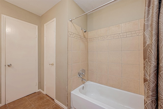 bathroom with tile patterned floors and shower / tub combo