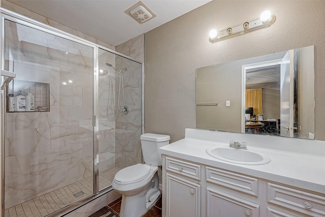 bathroom featuring vanity, toilet, walk in shower, and tile patterned flooring