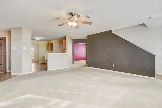 unfurnished living room with ceiling fan and light carpet