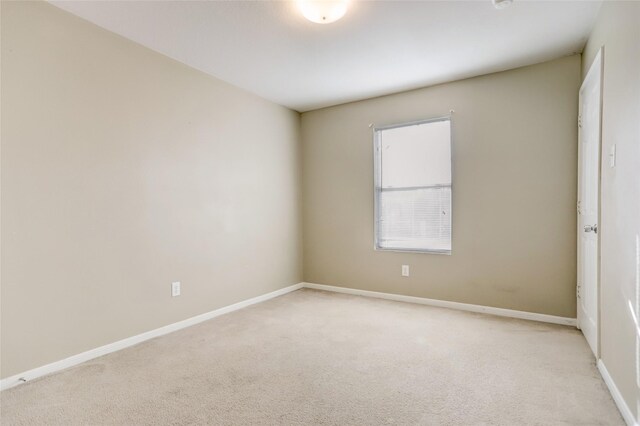 unfurnished room with light carpet