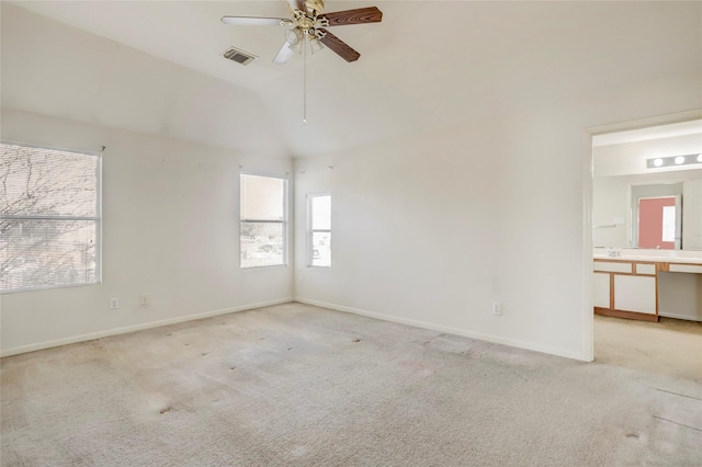 carpeted spare room with ceiling fan and lofted ceiling