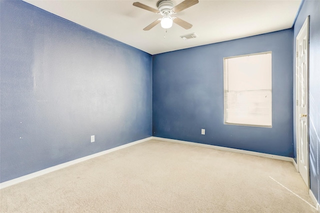 carpeted spare room featuring ceiling fan