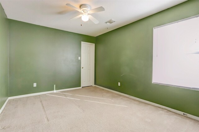 carpeted spare room with ceiling fan