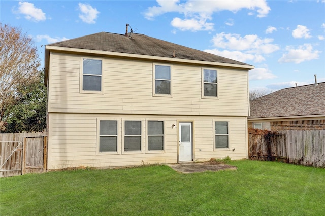 rear view of house with a lawn