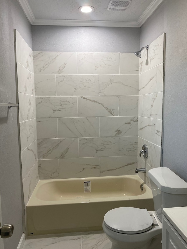 full bathroom featuring ornamental molding, toilet, tiled shower / bath combo, and vanity