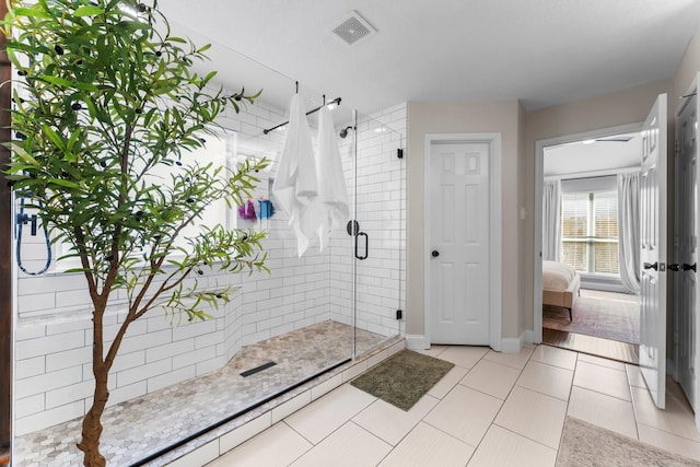 bathroom with tile patterned floors and a shower with shower door