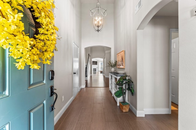 entryway featuring a high ceiling and an inviting chandelier