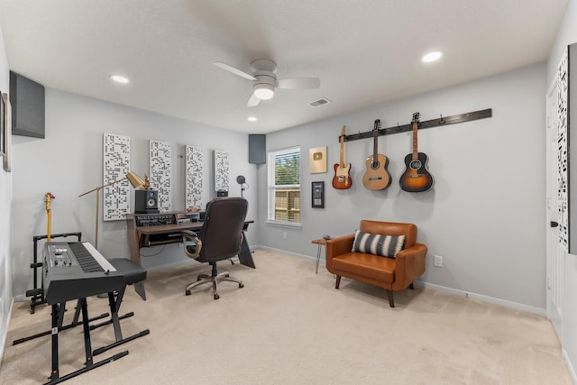 carpeted office featuring ceiling fan