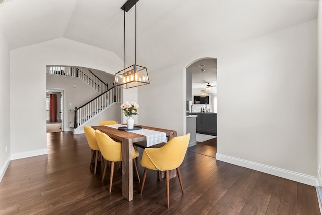 dining room with vaulted ceiling and dark hardwood / wood-style flooring