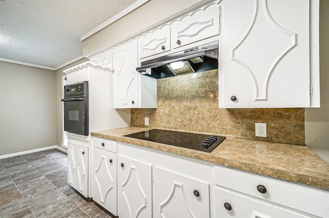 kitchen with black appliances, tasteful backsplash, and white cabinets