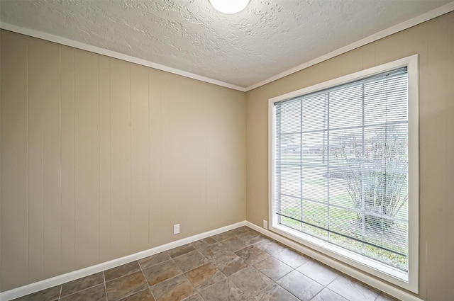 unfurnished room featuring a textured ceiling, crown molding, and wooden walls