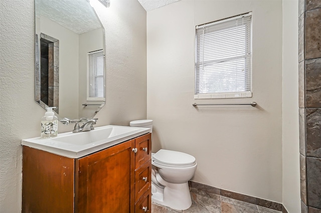 bathroom with toilet and vanity