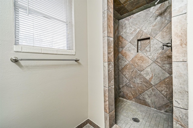 bathroom with tiled shower