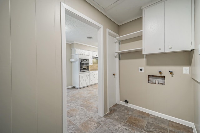 laundry room featuring hookup for an electric dryer, cabinets, a textured ceiling, and washer hookup