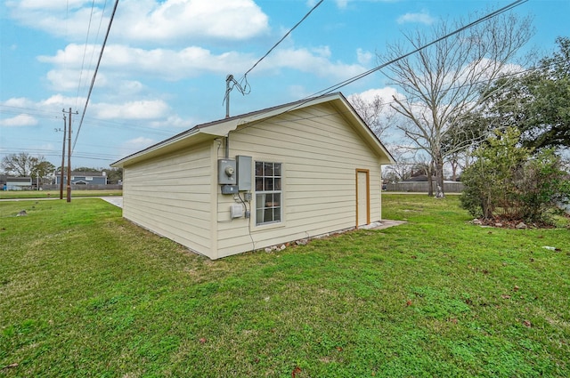 view of property exterior featuring an outdoor structure and a yard