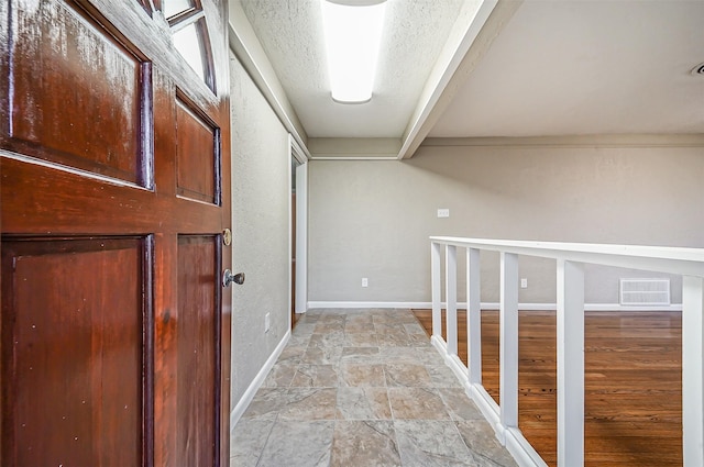 corridor with a textured ceiling