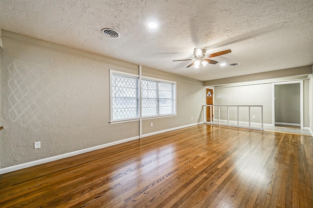 unfurnished room with ceiling fan, hardwood / wood-style floors, and a textured ceiling