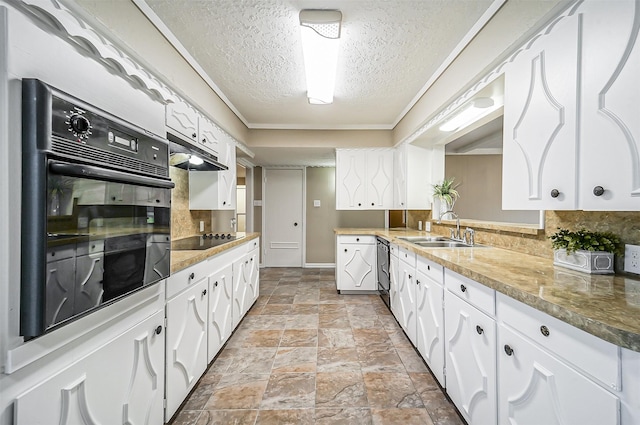 kitchen featuring sink, white cabinetry, black appliances, and a textured ceiling