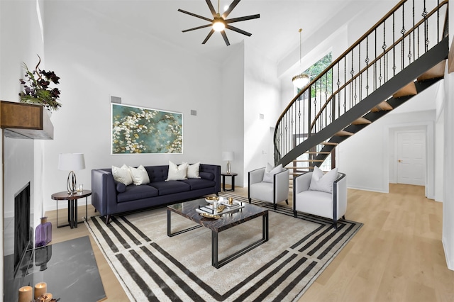 living room featuring light hardwood / wood-style floors and a high ceiling