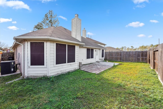 rear view of house with a lawn, a patio, and cooling unit