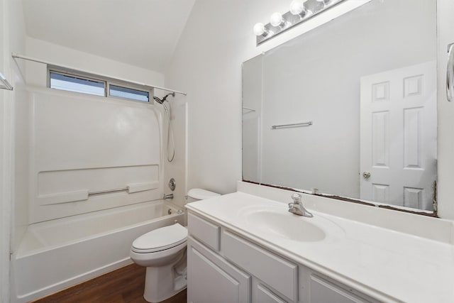 full bathroom with toilet, wood-type flooring, vanity, vaulted ceiling, and shower / washtub combination