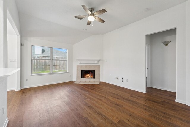 unfurnished living room featuring vaulted ceiling, ceiling fan, dark hardwood / wood-style floors, and a fireplace