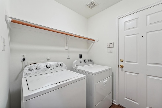 clothes washing area featuring washer and dryer