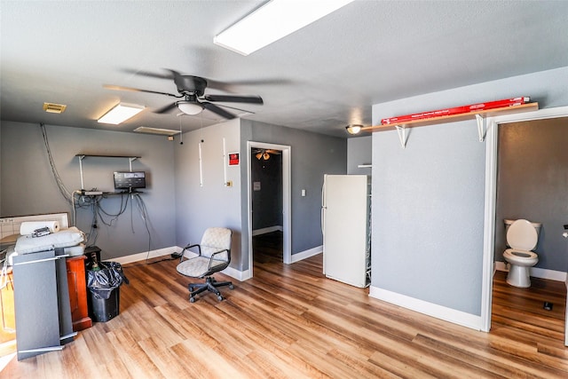 miscellaneous room with light hardwood / wood-style floors, a textured ceiling, and ceiling fan