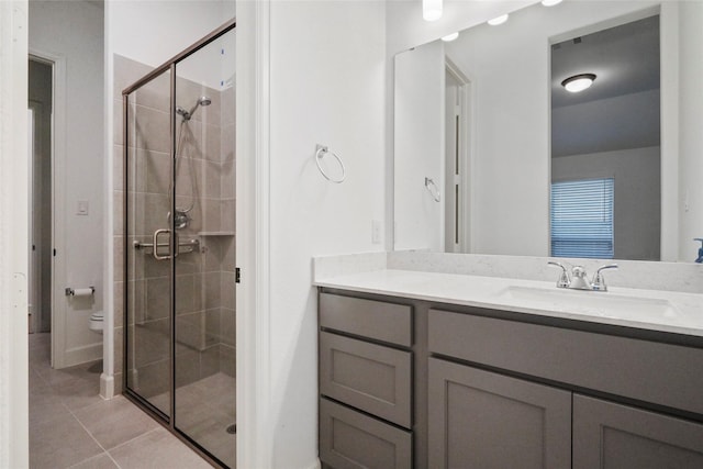 bathroom featuring vanity, tile patterned floors, and walk in shower