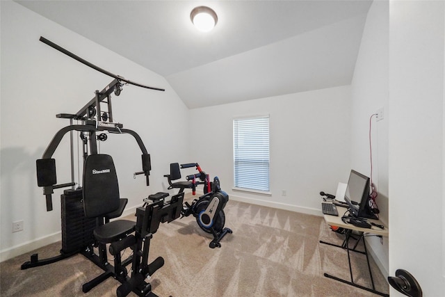 exercise area with lofted ceiling and light colored carpet