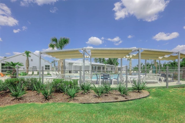 exterior space featuring a pool and a yard