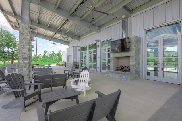 view of patio with ceiling fan, french doors, and an outdoor stone fireplace