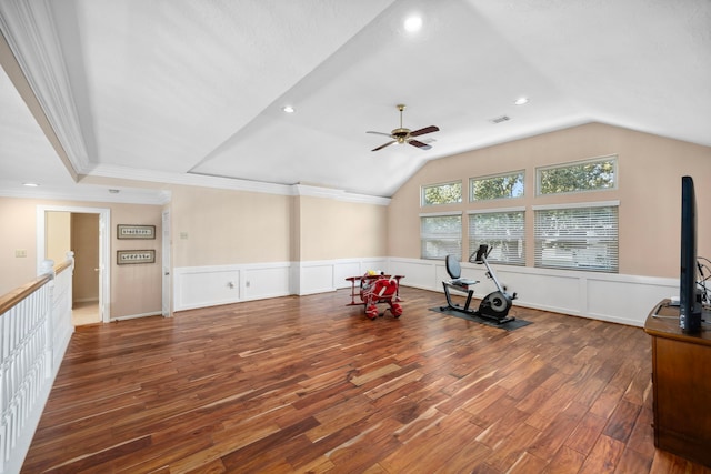 workout area featuring wood-type flooring, lofted ceiling, ornamental molding, and ceiling fan