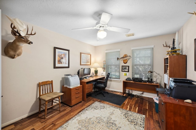 home office with dark wood-type flooring, a textured ceiling, and ceiling fan