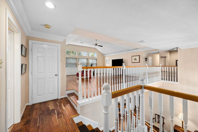 corridor with lofted ceiling, crown molding, and dark wood-type flooring