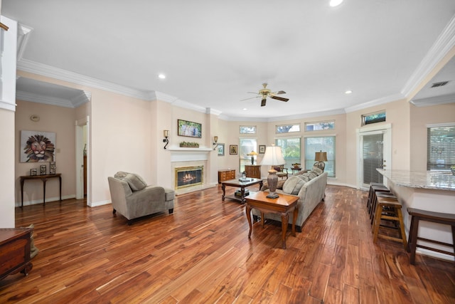 living room featuring crown molding, dark hardwood / wood-style floors, and ceiling fan