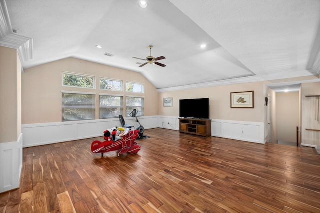 interior space with vaulted ceiling, dark wood-type flooring, crown molding, and ceiling fan