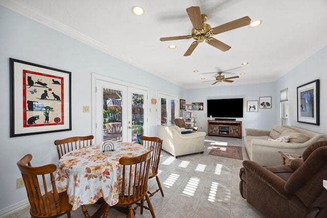 tiled dining area featuring french doors, ceiling fan, and crown molding