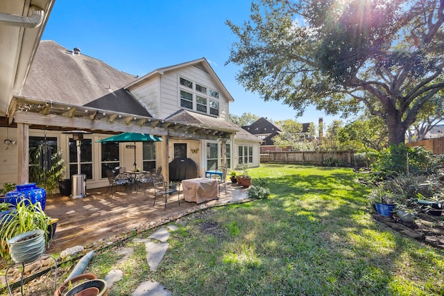 back of property featuring a pergola, a lawn, and a patio