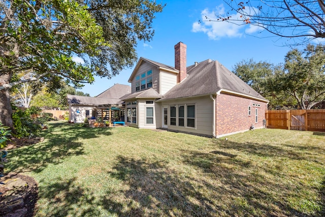 back of house with a lawn