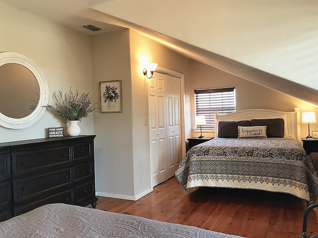 bedroom with wood-type flooring and a closet