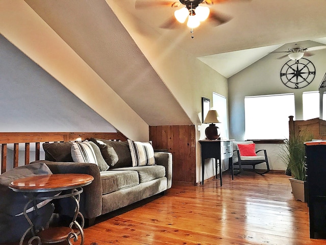 living room featuring lofted ceiling, light hardwood / wood-style flooring, and ceiling fan