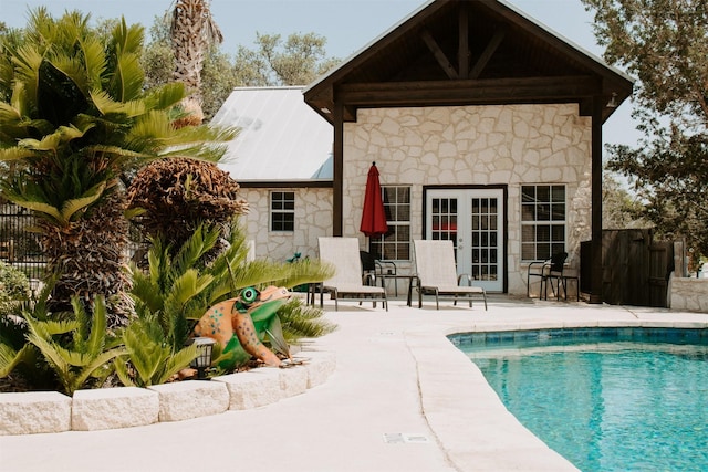 back of house with a fenced in pool, a patio area, and an outdoor structure