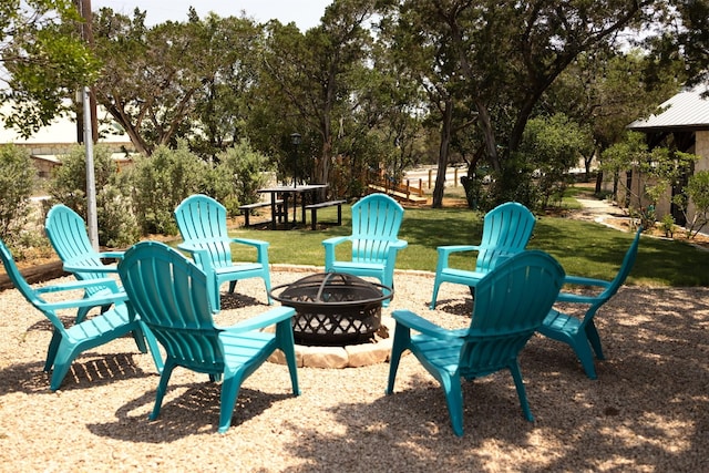 exterior space featuring an outdoor fire pit and a yard