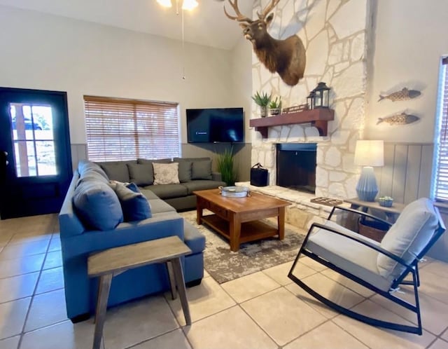 living room with a fireplace and light tile patterned floors