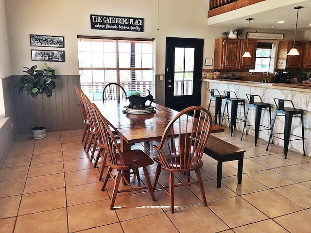 dining area with sink and light tile patterned flooring