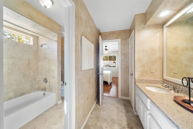 bathroom with vanity, tiled shower / bath combo, and tile patterned floors